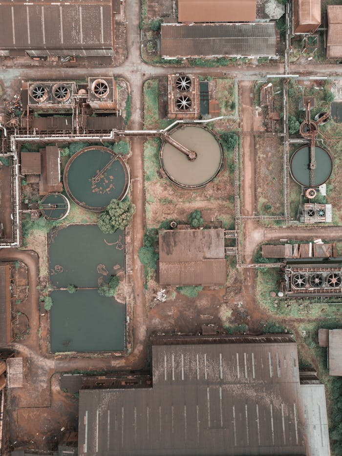 about-us-02 From above aerial view of industrial area of sewage treatment plant with round shaped water clarifiers